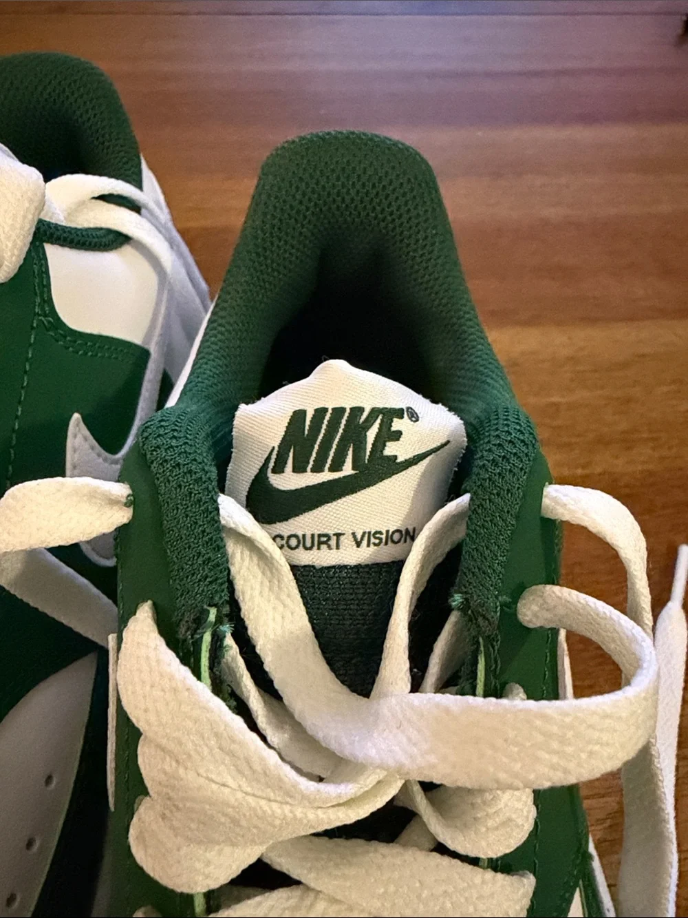 Nike White and Green Low-Top Sneakers — Classic Swoosh Design